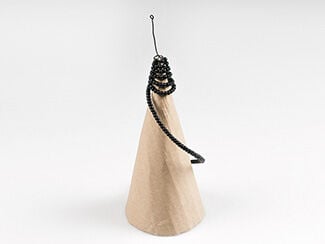 Cardboard cone with beaded wire spiraling around the top